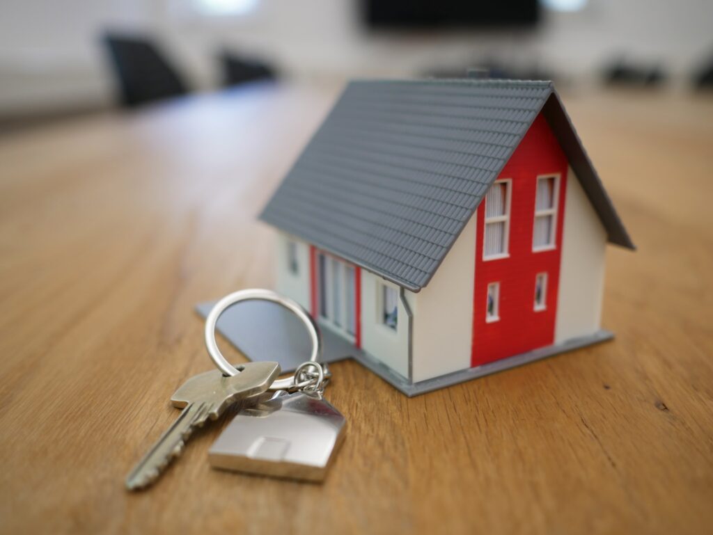 Toy home with keys, symbolizing real estate business success.